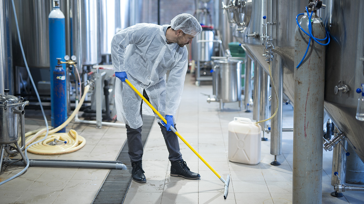 Professional industrial cleaner in protective uniform cleaning