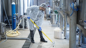 Professional industrial cleaner in protective uniform cleaning