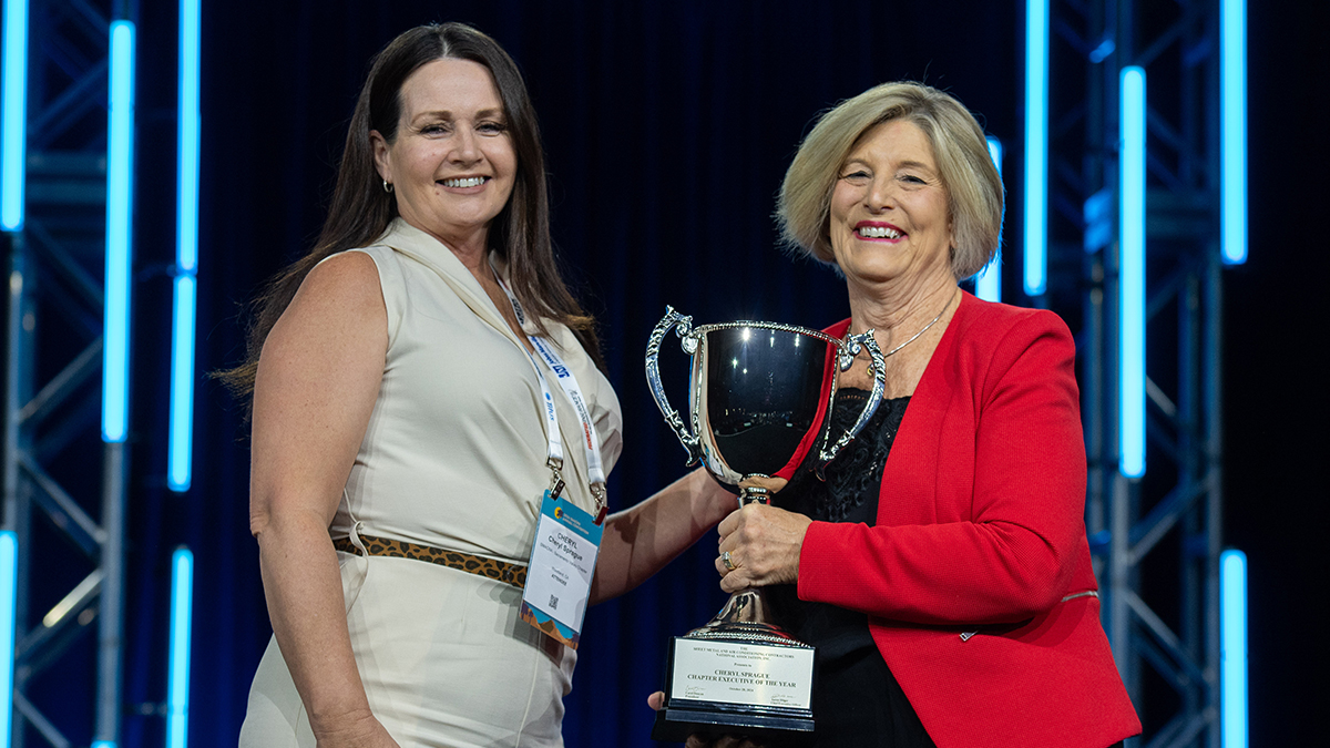 Two women receiving award